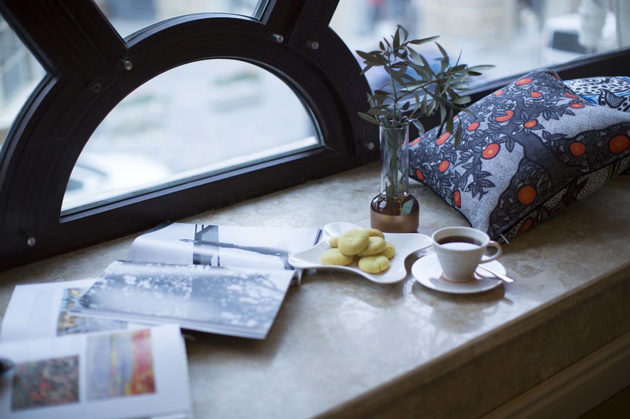 Boutique 19 Hotel Baku Exteriör bild A coffee table with a magazine and a cup of coffee